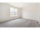 Large bedroom with a big window that lets in lots of natural light, gray carpet, and white walls at 9313 Biscay St, Commerce City, CO 80022