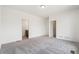 Spacious bedroom with gray carpet, white walls, and two doors at 9313 Biscay St, Commerce City, CO 80022