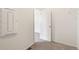 View of a walk-in closet space with a white door ajar looking into a bedroom at 9313 Biscay St, Commerce City, CO 80022