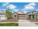 Charming single-story home with a stone facade and well-maintained front yard and an attached two car garage at 9313 Biscay St, Commerce City, CO 80022