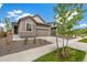 Home's exterior with neutral colors, stone accents, a driveway, and a two-car garage at 9313 Biscay St, Commerce City, CO 80022