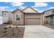 Charming single-Gathering home with stone accents, manicured landscaping, and a convenient two-car garage at 9313 Biscay St, Commerce City, CO 80022