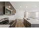 Kitchen features modern stainless steel appliances and an island with sink at 9313 Biscay St, Commerce City, CO 80022
