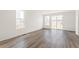 Inviting living room with hardwood floors and large windows, offering abundant natural light and a serene atmosphere at 9313 Biscay St, Commerce City, CO 80022