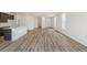 Bright and airy living room with hardwood floors, open layout, modern kitchen, and plenty of natural light at 9313 Biscay St, Commerce City, CO 80022