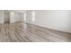 Light-filled living room with hardwood floors, neutral walls, and bright windows, creating a welcoming atmosphere at 9313 Biscay St, Commerce City, CO 80022