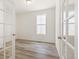 Office with French doors, a large window, wood flooring, and white walls at 9313 Biscay St, Commerce City, CO 80022