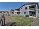 Spacious backyard features a well-kept lawn, decorative gravel, and a charming white picket fence at 3945 John Ave, Castle Rock, CO 80104
