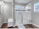 Modern bathroom featuring a tiled shower with glass door, a bench, and a decorative mosaic tile accent at 3945 John Ave, Castle Rock, CO 80104