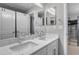 Bathroom with double sink vanity, framed mirrors and white cabinets at 3945 John Ave, Castle Rock, CO 80104