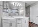 Well-lit bathroom features a double vanity with quartz countertop and a large mirror at 3945 John Ave, Castle Rock, CO 80104