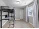 Cozy bedroom with a black metal loft bed frame and soft carpeting and neutral decor at 3945 John Ave, Castle Rock, CO 80104
