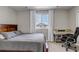 Bedroom featuring a queen-sized bed, work desk and neutral carpeting at 3945 John Ave, Castle Rock, CO 80104