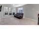 Bonus room with plush carpet, natural light, and a comfy reclining sofa at 3945 John Ave, Castle Rock, CO 80104