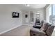 Bonus room with plush carpet, natural light, a TV, and a comfy reclining sofa at 3945 John Ave, Castle Rock, CO 80104