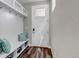 Mud room with bench, hooks, and storage shelves adjacent to front door at 3945 John Ave, Castle Rock, CO 80104