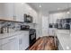 Stylish kitchen featuring white cabinetry, modern appliances, and a tiled backsplash at 3945 John Ave, Castle Rock, CO 80104