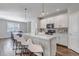 Modern kitchen featuring white cabinets, sleek appliances, and a center island with seating at 3945 John Ave, Castle Rock, CO 80104