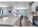 Bright kitchen with white cabinets, stainless appliances, a large island and an open concept design at 3945 John Ave, Castle Rock, CO 80104