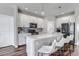 Modern kitchen featuring white cabinets, sleek appliances, and a center island with seating at 3945 John Ave, Castle Rock, CO 80104