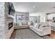 Comfortable living room with a large stone fireplace, large sectional sofa and an open floor plan at 3945 John Ave, Castle Rock, CO 80104