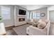 Comfortable living room with stone fireplace, large sectional sofa and lots of natural light at 3945 John Ave, Castle Rock, CO 80104