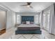 Bright main bedroom with a tufted headboard, ceiling fan, and large windows for natural light at 3945 John Ave, Castle Rock, CO 80104