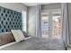 Close up of the main bedroom featuring a private balcony with natural light beaming through the blinds at 3945 John Ave, Castle Rock, CO 80104
