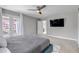 Main bedroom with private balcony, TV, ceiling fan, and ensuite access through a sliding barn door at 3945 John Ave, Castle Rock, CO 80104