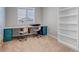 Bright office space with large desk and built in shelving, perfect for working from home at 3945 John Ave, Castle Rock, CO 80104