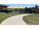 Enjoy the pool with yellow umbrellas in a charming community setting surrounded by lush greenery at 3945 John Ave, Castle Rock, CO 80104