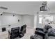 Finished basement theater room with a projector, screen, and comfortable leather reclining seating at 3945 John Ave, Castle Rock, CO 80104