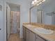 Bathroom featuring a double sink vanity and tiled shower with decorative accents at 9338 W 107Th Mews, Westminster, CO 80021