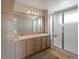 Well-lit bathroom featuring a double vanity, large mirror, and a glass-enclosed shower at 9338 W 107Th Mews, Westminster, CO 80021