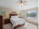 Serene bedroom with a ceiling fan, large windows, and classic wooden furniture at 9338 W 107Th Mews, Westminster, CO 80021