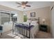 Charming bedroom with a metal frame bed, ceiling fan, and sun-filled windows at 9338 W 107Th Mews, Westminster, CO 80021