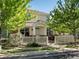 Charming two-story home with a manicured front yard and white picket fence under a bright blue sky at 9338 W 107Th Mews, Westminster, CO 80021