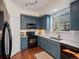 Modern kitchen with granite countertops, stainless steel appliances, and stylish blue cabinetry at 9338 W 107Th Mews, Westminster, CO 80021