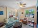 Bright living room with a large window, hardwood floors, and comfortable seating arrangement at 9338 W 107Th Mews, Westminster, CO 80021