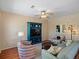 Comfortable living room featuring a stylish entertainment center, ceiling fan, and modern furnishings at 9338 W 107Th Mews, Westminster, CO 80021