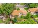 Aerial view showcasing backyard, patio, mature trees, and shed at 1235 S Benton St, Lakewood, CO 80232