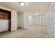 Spacious unfinished basement with a door, and partial wallpaper at 1235 S Benton St, Lakewood, CO 80232