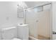 Tiled bathroom featuring a vanity, toilet, and glass-enclosed shower at 1235 S Benton St, Lakewood, CO 80232