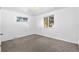 Bright bedroom features neutral carpet and two windows providing plenty of natural light at 1235 S Benton St, Lakewood, CO 80232