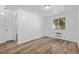 Cozy bedroom featuring wood-look floors, neutral walls, and a bright window at 1235 S Benton St, Lakewood, CO 80232
