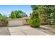 Lovely home featuring well-kept front yard, mature trees, and attached garage at 1235 S Benton St, Lakewood, CO 80232