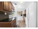 Kitchen featuring dark cabinets, black counters, neutral walls, and basic white appliances at 1235 S Benton St, Lakewood, CO 80232