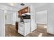 Functional kitchen layout featuring dark cabinets, black counters, and basic white appliances at 1235 S Benton St, Lakewood, CO 80232