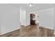 Open-concept living area showcasing wood-look floors, neutral walls, and a glimpse into the kitchen at 1235 S Benton St, Lakewood, CO 80232