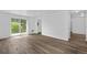 Bright living room featuring wood-look floors and sliding glass doors to the backyard at 1235 S Benton St, Lakewood, CO 80232